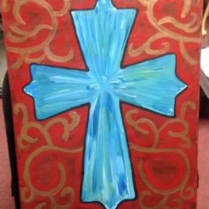Blue cross canvas painting on burgundy background